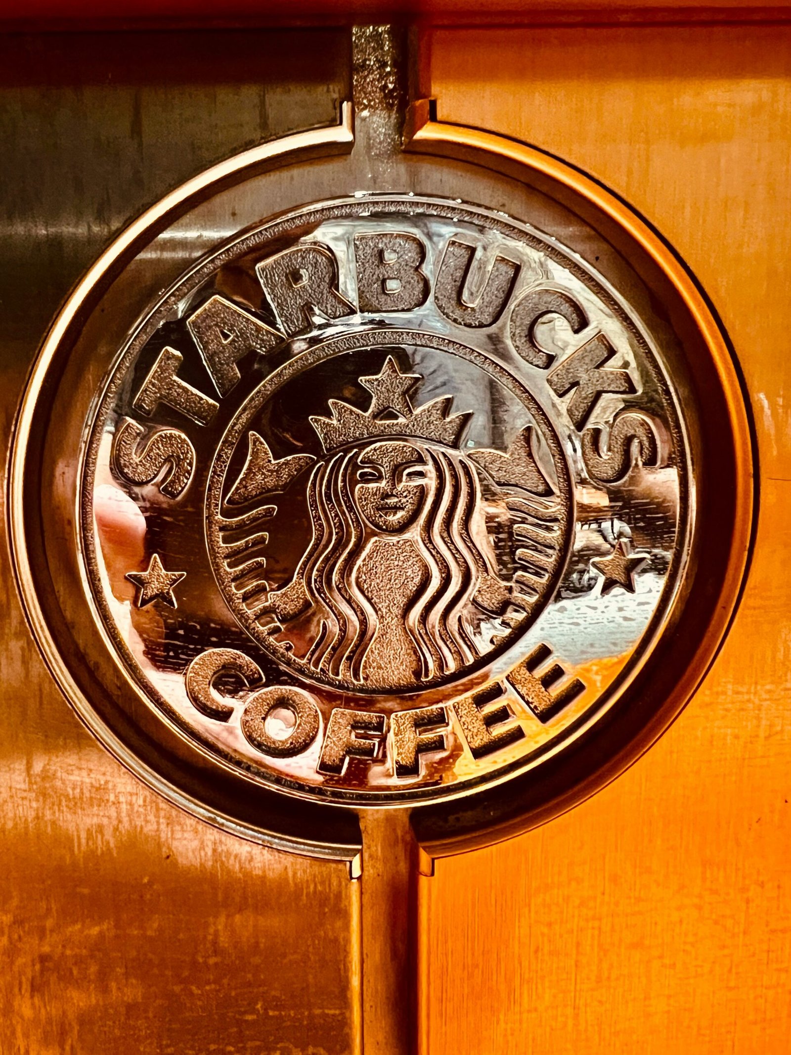 a close up of a starbucks sign on a door